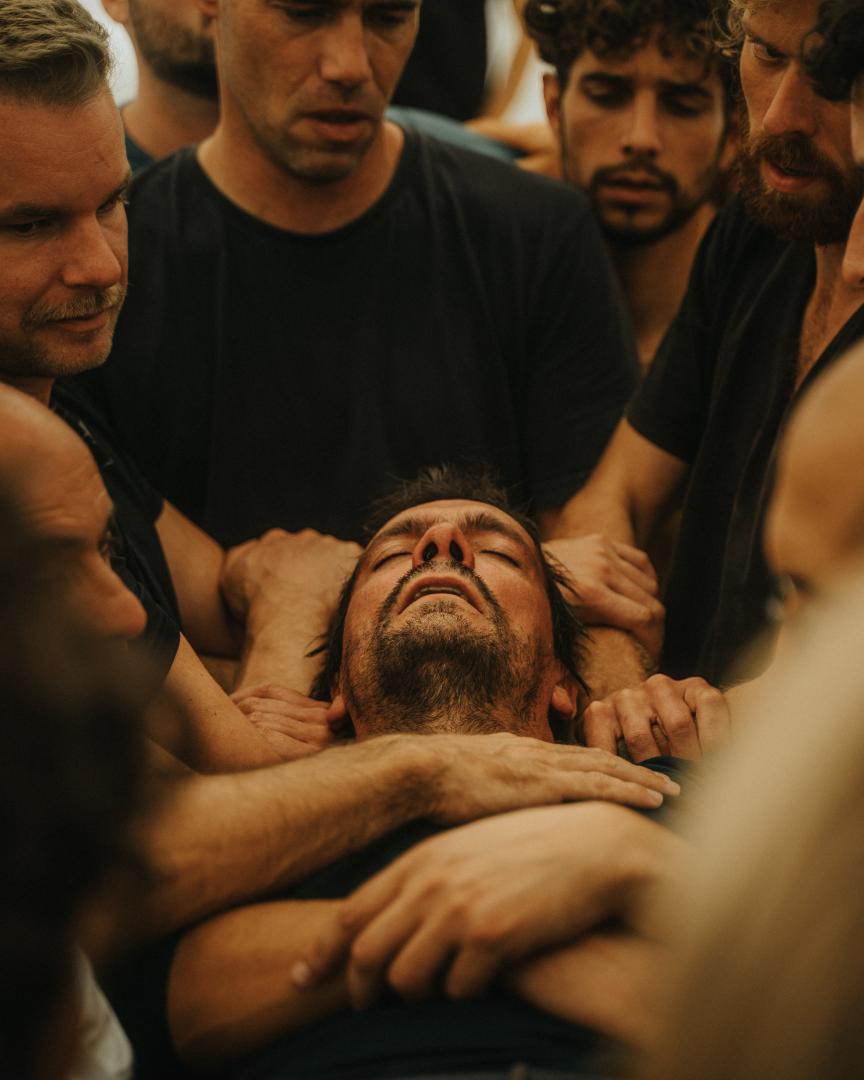 Men's Academy gathering around the fire at night